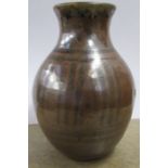 WITHDRAWN A Peter Arnold Alderney Pottery vase, decorated in black to a brown ground