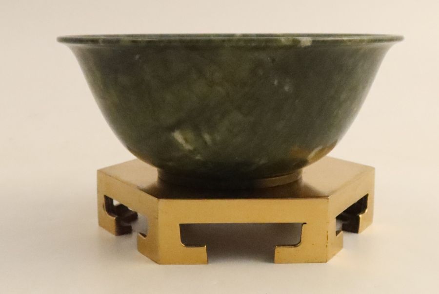 A Chinese simulated spinach jade bowl, of circular form on gilt metal stand