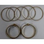 A pair of bangles, with acorn terminals, together with five bangles