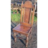 An Antique oak hall chair, with solid seat