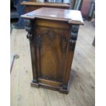 A 19th century rosewood bedside cabinet, the door with carved decoration opening to reveal a