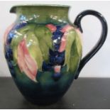 A Moorcroft Pottery jug, decorated in the leaf and berry pattern, height 8ins