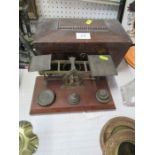 A set of Mordan & Co gilt metal scales, on mahogany plinth with weights, together with a tea caddy