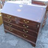 A large 19th century mahogany bureau, with inlaid decoration to the fall flap, fitted with a