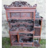 A Chinese hardwood cabinet section, fitted with cupboards having sliding panel doors and shelves,