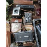 Four vintage cameras in cases, to include a Zeiss Ikon Cocarene folding camera, a Zeiss Ikon