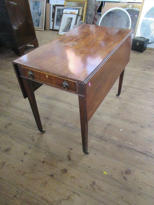 A 19th century mahogany Pembroke table, with drop flaps and fitted with one real and one dummy