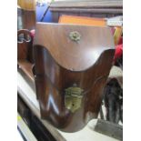 An Antique mahogany knife box, with sloping hinged lid, having a serpentine front, brass mounts,