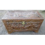 An Eastern design carved blanket chest  42" x20" x 231/2" and contents