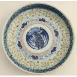 An 18th century Chinese plate, the central panel decorated with a bird to a stylised foliate border,