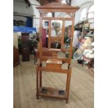 An Edwardian oak hall stand, with mirror, coat hooks, glove box and stick stand, height 77ins, width