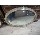 An oval gilt framed mirror