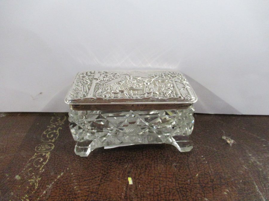 A silver topped glass dressing table box, of rectangular form, the silver top embossed with