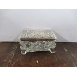 A silver topped glass dressing table box, of rectangular form, the silver top embossed with