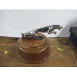 A Jaguar car mascot on a wooden base