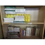 Two shelves of cricket related books, to include Wisden, programmes etc