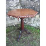 A 19th century octagonal oak tripod table , width 21ins