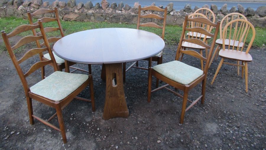 An Ercol gate leg table, together with 4 ladder backed Ercol chairs and 4 kitchen chairs