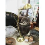 A brass coloured angle poise desk lamp