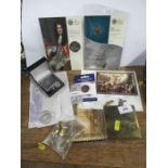 A collection of commemorative coins, military buttons, badges etc