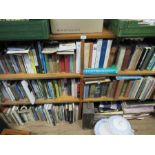 Six shelves of books together with a box of books