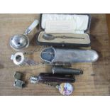 A collection of silver items, to include a spectacles case, a spoon, babies rattle etc