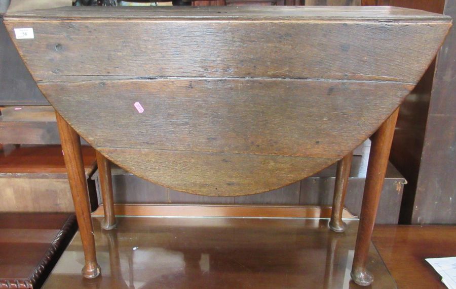 An antique oak gate leg table, raised on cabriole legs, terminating in pad feet, width 37ins, height