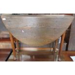 An antique oak gate leg table, raised on cabriole legs, terminating in pad feet, width 37ins, height