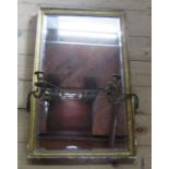 An Antique rectangular gilt framed wall mirror, with two gilt metal candleholders, 29ins x 18ins