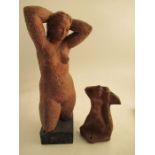 A clay model of a female torso, attributed to Karin Jonzen, with her hands behind her head raised on