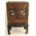 An Eastern lacquered table top cabinet on stand, decorated with birds and flowers, fitted with