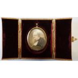 A 19th century oval portrait miniature, painted on ivory of a woman reading, maximum diameter 2.