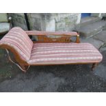 An Edwardian chaise longue, with pierced and carved rail