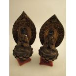 A pair of carved Eastern sconces of seated  praying figures  within an arbor height 8 1/2"