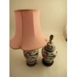 A pair of Eastern decorated table lamps,  raised on wooden bases, height 14ins