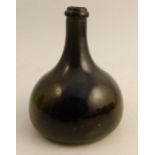 An 18th century Georgian green glass onion shaped wine bottle, molded makers mark A.J. G& F
