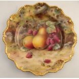 A Royal Worcester cabinet plate, decorated with fruit to a mossy background by T Lockyear, with