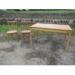 An Ercol kitchen table, 27ins x 48ins, height 28ins, together with two kitchen chairs