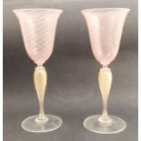 A pair of Venetian glass wine glasses, with pink and white stripe bowl and yellow twist stem, height