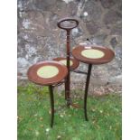 A mahogany three tiered cake stand, with central handle and three circular dishes at different