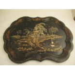 A 19th century toleware tray the ebonized ground decorated in guilt and mother of pearl with a