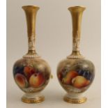 A pair of Royal Worcester vases, the fronts decorated with fruit to a mossy background by