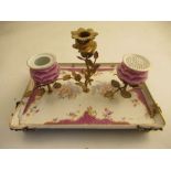 A continental porcelain desk tray with armorial mounts supporting Ink well, pounce pot and a