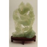 A jade study, of two Phoenix against a foliate background, height including stand 10ins