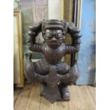 A carved wooden model, possibly a tray or table base, in the form of an eastern figure, height 16ins