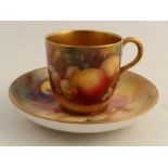 A Royal Worcester cup and saucer, the exterior of the cup and the saucer decorated with fruit to a