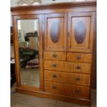 An Edwardian mahogany and inlaid wardrobe, with mirror door, a pair of cupboard doors opening to