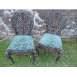 A pair of Anglo-Indian hardwood chairs, with pierced and carved decoration - Both chairs are