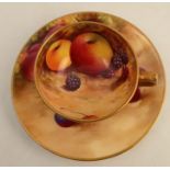 A Royal Worcester miniature cup and saucer, the interior of the cup and the saucer decorated with