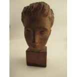 A clay head of a young boy signed to the reverse Karin Jonzen, raised on a wooden pedestal  height